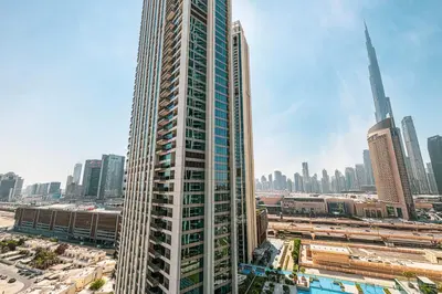 a tall building in the middle of a city at Downtown Dreams Burj Khalifa View with Dubai Mall, Pool & Free Parking in Dubai