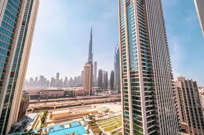 a view of a large city with tall buildings at Downtown Dreams Burj Khalifa View with Dubai Mall, Pool & Free Parking in Dubai