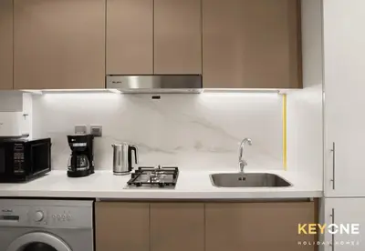 a kitchen with a sink and a microwave at Azizi Riviera Studio with Chic Furnishing in Dubai