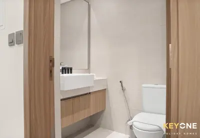 a bathroom with a sink and a toilet at Azizi Riviera Studio with Chic Furnishing in Dubai