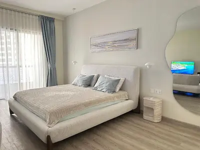 a bedroom with a bed and a mirror at Rimal 2 JBR Studio 70m2 beach, gym, pool in Dubai