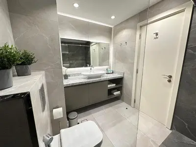 a bathroom with a toilet and a sink and a mirror at Rimal 2 JBR Studio 70m2 beach, gym, pool in Dubai