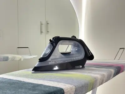 a black iron sitting on top of a bed at Rimal 2 JBR Studio 70m2 beach, gym, pool in Dubai