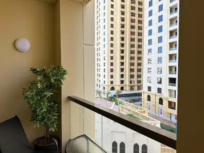 a balcony with a view of a tall building at Rimal 2 JBR Studio 70m2 beach, gym, pool in Dubai