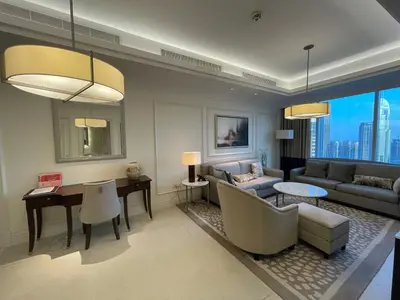 a living room with a couch and a table at Apt Dubai Downtown in Dubai