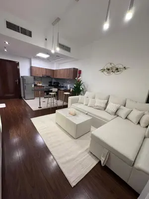 a living room with a white couch and a kitchen at Live a life of luxury in Dubai