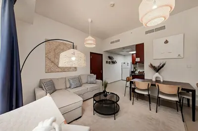 a living room with a couch and a table at Cozy 1BR apartment in JBR in Dubai