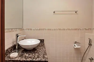 a bathroom with a white sink on a counter at Cozy 1BR apartment in JBR in Dubai