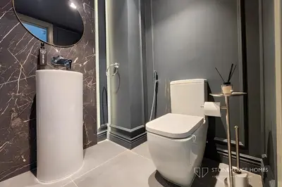 a bathroom with a white toilet and a mirror at Chic 1 Bedroom Apartment in Dubai Marina, Marina View, Near JBR in Dubai