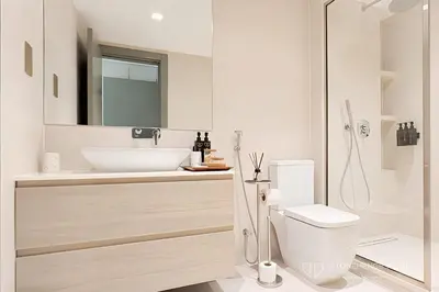 a white bathroom with a sink and a toilet at Chic 1 Bedroom Apartment in Dubai Marina, Marina View, Near JBR in Dubai