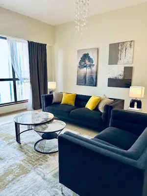 a living room with a couch and a table at JBR bed-space in Dubai