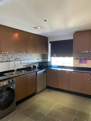 a kitchen with a sink and a washing machine at JBR bed-space in Dubai