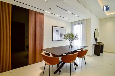 a dining room with a table and chairs at Luxury Escapes - Luxurious 2-Bedroom Apartment with Stunning Lake Views in JBR in Dubai