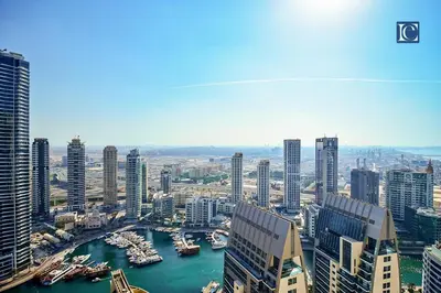 a view of a city with boats in a harbor at Luxury Escapes - Luxurious 2-Bedroom Apartment with Stunning Lake Views in JBR in Dubai