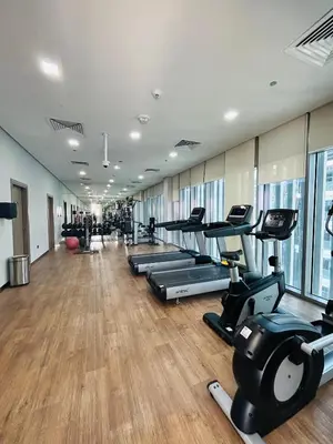 a gym with treadmills and elliptical machines at MontRose Residence Tower A in Dubai