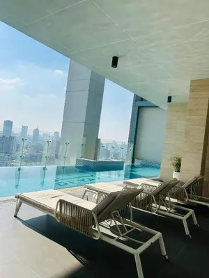 a pool in a building with chairs and a swimming pool at MontRose Residence Tower A in Dubai