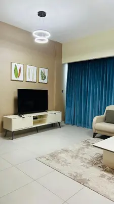a living room with a television and a couch at MontRose Residence Tower A in Dubai