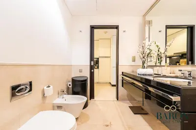 a bathroom with a sink and a toilet and a counter at The Signature in Dubai