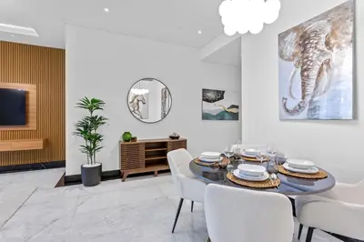 a dining room with a table and chairs at Lush Living with Jacuzzi and Burj Khalifa View in Dubai