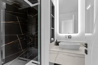 a bathroom with a white sink and a mirror at Lush Living with Jacuzzi and Burj Khalifa View in Dubai