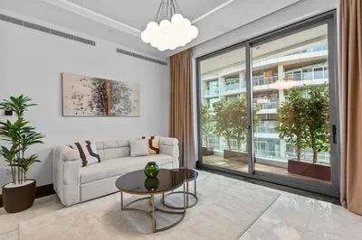 a living room with a couch and a table at Lush Living with Jacuzzi and Burj Khalifa View in Dubai