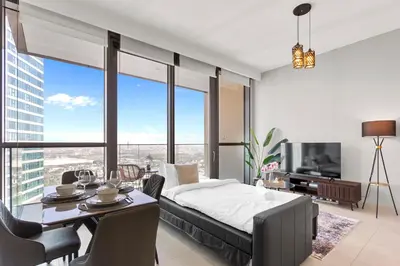 a bedroom with a bed and a table and chairs at Luxury 1 Bedroom in the Heart of Famous Downtown in Dubai