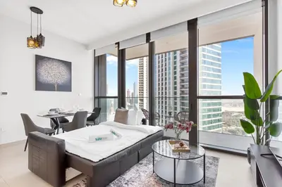 a bedroom with a bed and a table and chairs at Luxury 1 Bedroom in the Heart of Famous Downtown in Dubai
