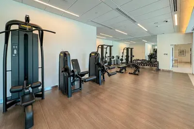 a gym with several rows of tread machines in a room at Luxury 1 Bedroom in the Heart of Famous Downtown in Dubai