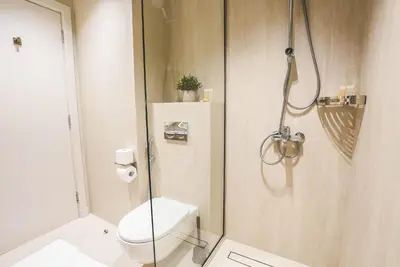 a bathroom with a toilet and a glass shower at Marina Sea View,Elegant and Spacious - High Floor in Dubai
