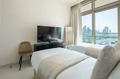 a hotel room with two beds and a flat screen tv at Frank Porter - Sunrise Tower in Dubai