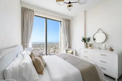 a bedroom with a bed with a large window at 1BR Forte 2, Skyline City View in Dubai
