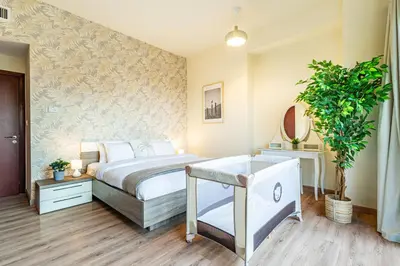 a bedroom with a bed and a potted plant at Family & Group Paradise - JBR Beach 3 min walk - Ain Dubai Views - Heart of JBR - 14 People in Dubai