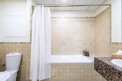 a bathroom with a tub and a toilet and a sink at Family & Group Paradise - JBR Beach 3 min walk - Ain Dubai Views - Heart of JBR - 14 People in Dubai
