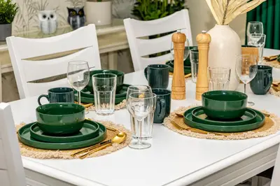 a white table with green plates and glasses on it at Family & Group Paradise - JBR Beach 3 min walk - Ain Dubai Views - Heart of JBR - 14 People in Dubai