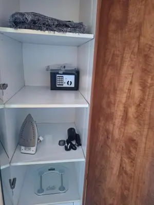 a book shelf with a toaster and a radio at Bright Studio Unit at Lake Terrace with lake view in Dubai