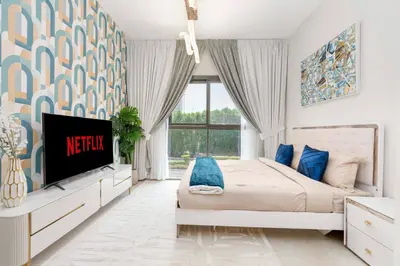 a bedroom with a bed and a tv in it at Ahlan HH - Stunning Studio in Eleganz 2 Danube, JVC in Dubai