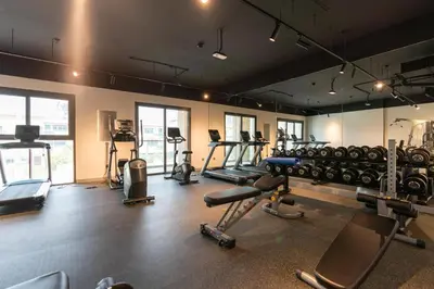 a gym with a lot of treadmills and machines at Ahlan HH - Stunning Studio in Eleganz 2 Danube, JVC in Dubai