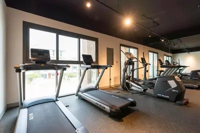 a gym with two treadmills and two exercise bikes at Ahlan HH - Stunning Studio in Eleganz 2 Danube, JVC in Dubai