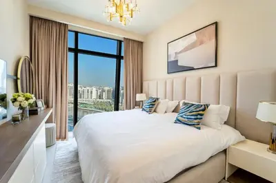 a bedroom with a large white bed and a large window at NEW Exceptional Lagoon View - 2 Stylish Bedrooms in Dubai