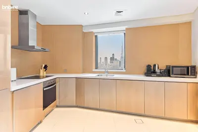 a kitchen with a sink and a microwave at bnbmehomes - DAMAC Towers Paramount in Dubai