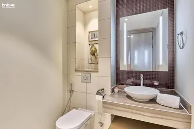 a bathroom with a sink and a toilet at bnbmehomes - DAMAC Towers Paramount in Dubai