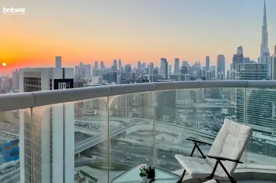 a balcony with a chair and a view of a city at bnbmehomes - DAMAC Towers Paramount in Dubai