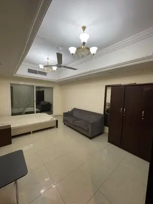 a living room with a couch and a ceiling at Lavish Room with family environment in Dubai