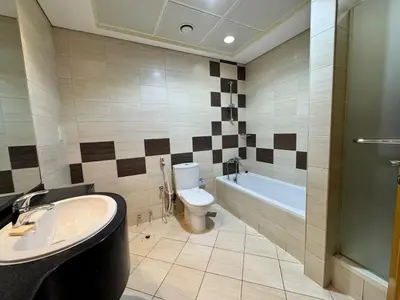 a bathroom with a sink and a toilet and a tub at Lavish Room with family environment in Dubai