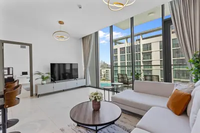 a living room with a couch and a table at Superb 1 Bedroom with Burj Khalifa and Lagoon View in Dubai