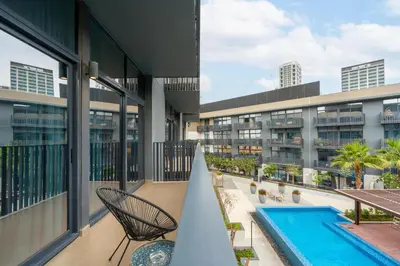 a view of a building with a swimming pool at Ahlan HH - Beautiful 1BR Home with Pool View - Belgravia III, JVC in Dubai