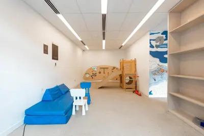 a room with a blue couch and a bunk bed at Ahlan HH - Beautiful 1BR Home with Pool View - Belgravia III, JVC in Dubai