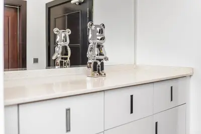 a bathroom with a white sink and a mirror at Trendy Fully Equipped Beautiful Apartment for Four near to Metro in Dubai