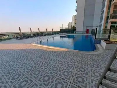 a large swimming pool on the side of a building at Trendy Fully Equipped Beautiful Apartment for Four near to Metro in Dubai