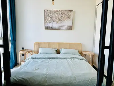 a bedroom with a bed and a picture on the wall at Sunny 1 Bedroom Apartment in Dubai Hills Estate in Dubai